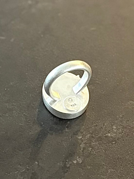 Reerse side of Bespoke Dendritic Agate Ring showing a matte sterling silver backplate with a round disc stamped with the 925 hallmark and maker’s mark, featuring a chunky, anti-spin U-shaped band profile.