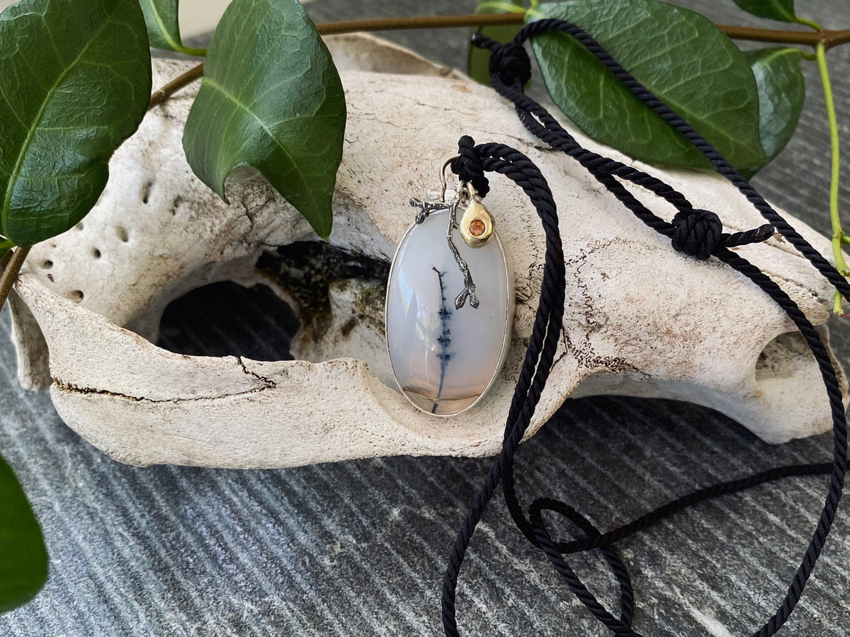 Archival contemporary pendant featuring a dendritic agate cabochon set in sterling and fine silver with a recycled 9ct gold dangle element.
